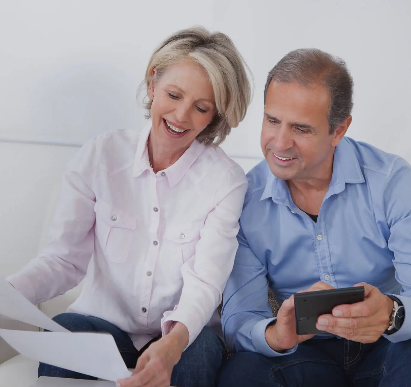 mature couple calculating their finance manage debt